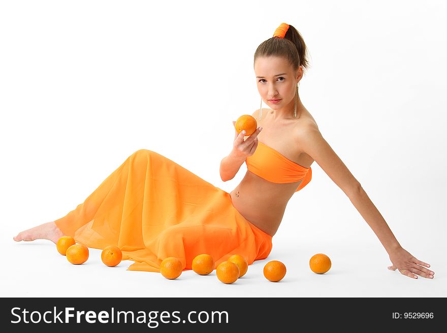The girl in an orange dress with oranges