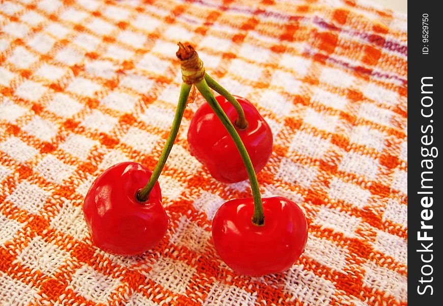 Three fresh bright red cherries. Three fresh bright red cherries.