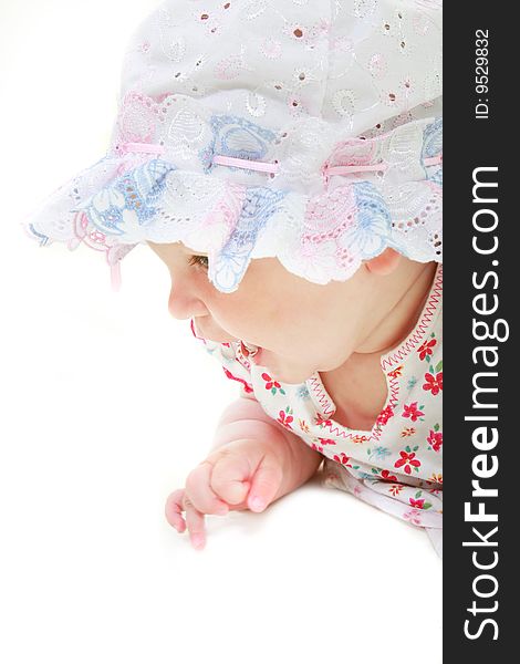 Baby girl in hat portrait over white