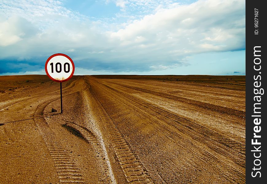 A desert landscape with a speed limit sign. A desert landscape with a speed limit sign.