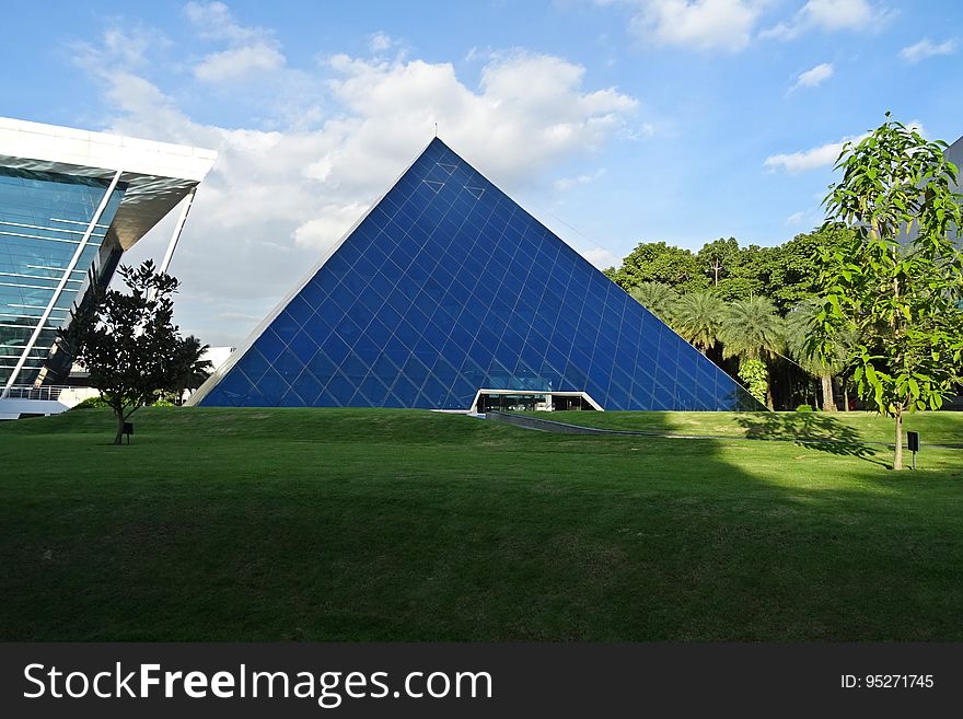 The exterior of a glass pyramid.