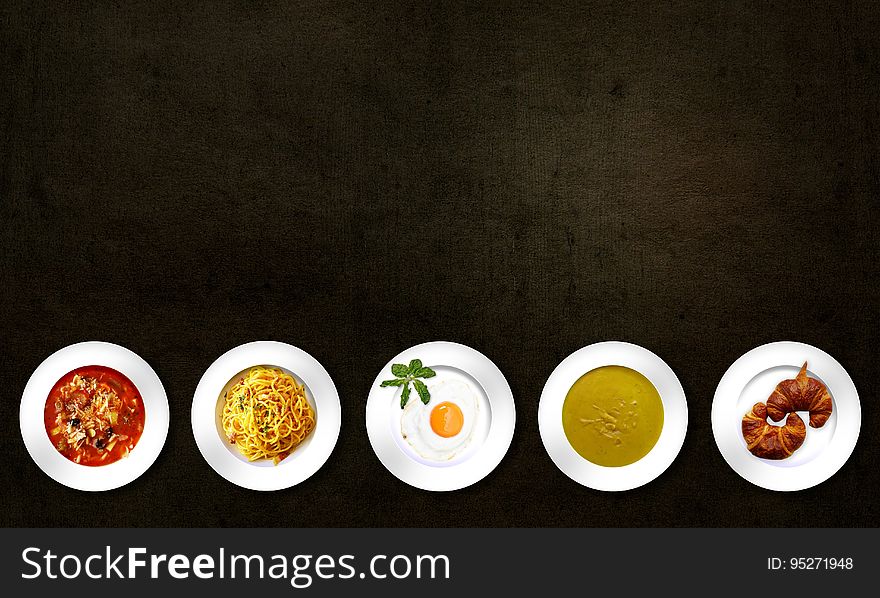 Five White Plates With Different Kinds of Dishes