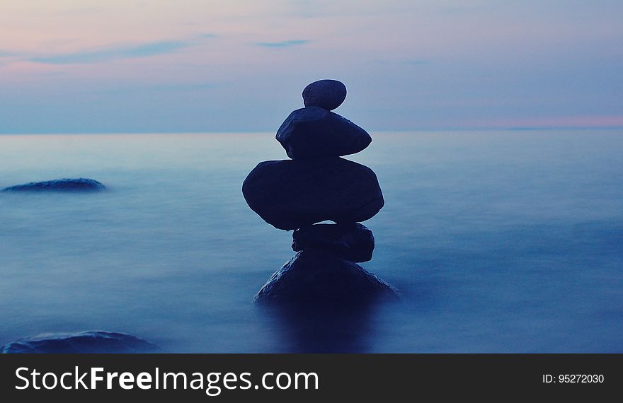 A stack of balanced stones in the sea. A stack of balanced stones in the sea.