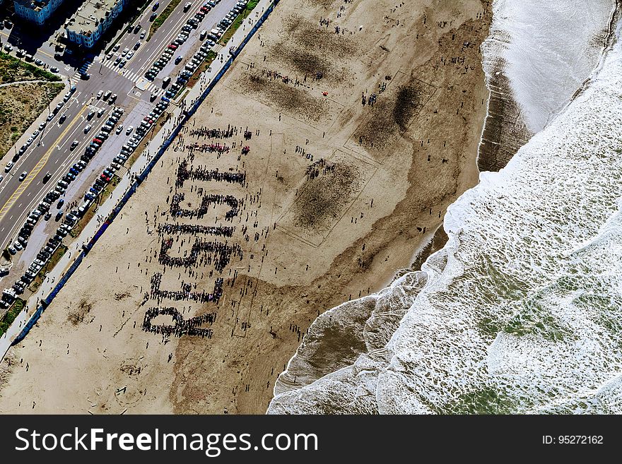 The word "resist" written on beach seen from the air.