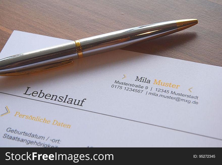 Pen resting on top of a German business document. Pen resting on top of a German business document.