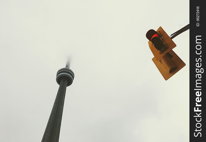 Viewing looking up to red traffic light and Fernsehturm tower in Berlin. Viewing looking up to red traffic light and Fernsehturm tower in Berlin.