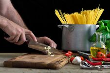 Man сooking An Italian Pasta On Light Wooden Table Royalty Free Stock Image