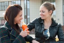 Two Girls Drink Juice Stock Images