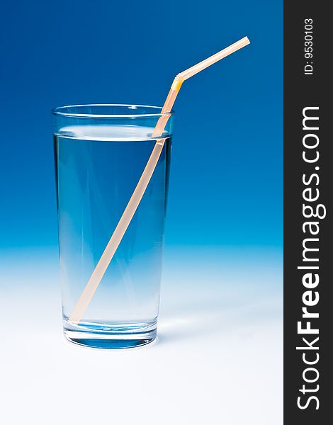 Glass of water on blue gradient background