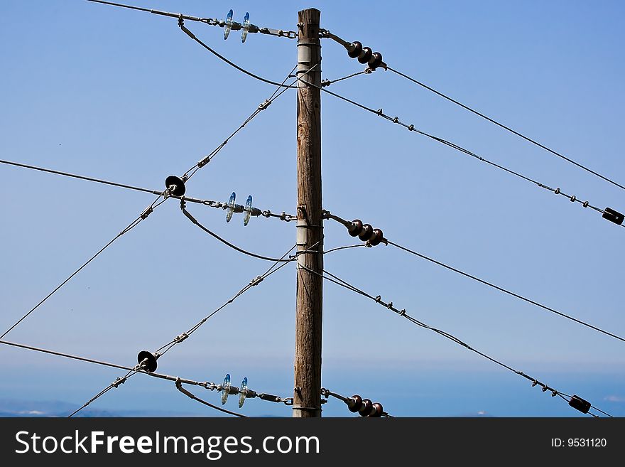 Electricity pole over a blue sky