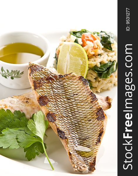 Grilled fish with rice and lemon sauce