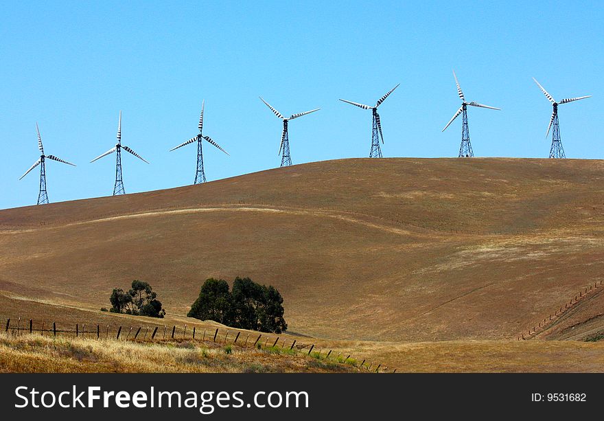 Power generating wind turbines on the field. Power generating wind turbines on the field