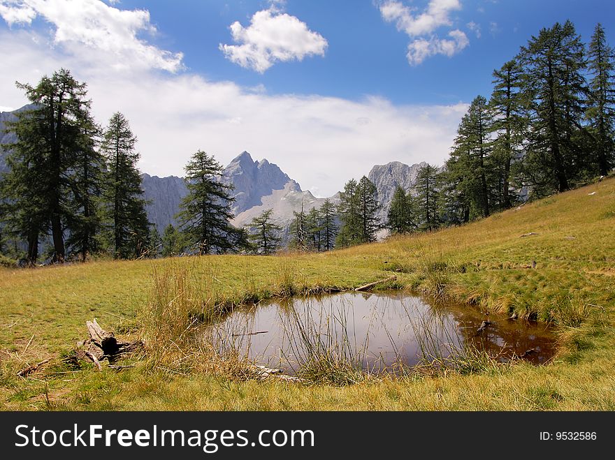 Jalovec peak in Julian national park Alps Slovenia with small lake