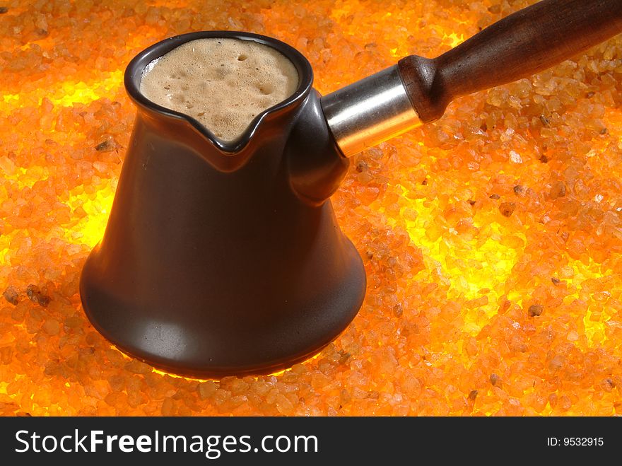 Coffee pot standing on the hot sand