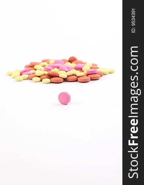 Small group of pills and vitamins on a white background. Small group of pills and vitamins on a white background