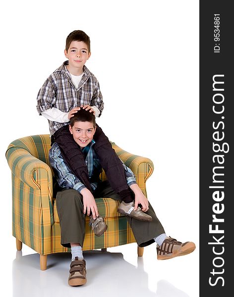 Two young happy smiling boys playing in the chair. Two young happy smiling boys playing in the chair