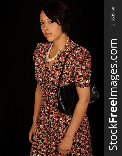 A closeup portrait of a pretty African American teenage woman.  Black background. A closeup portrait of a pretty African American teenage woman.  Black background