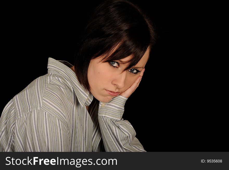 A formal portrait of a dark haired teenage girl. Black background. A formal portrait of a dark haired teenage girl. Black background