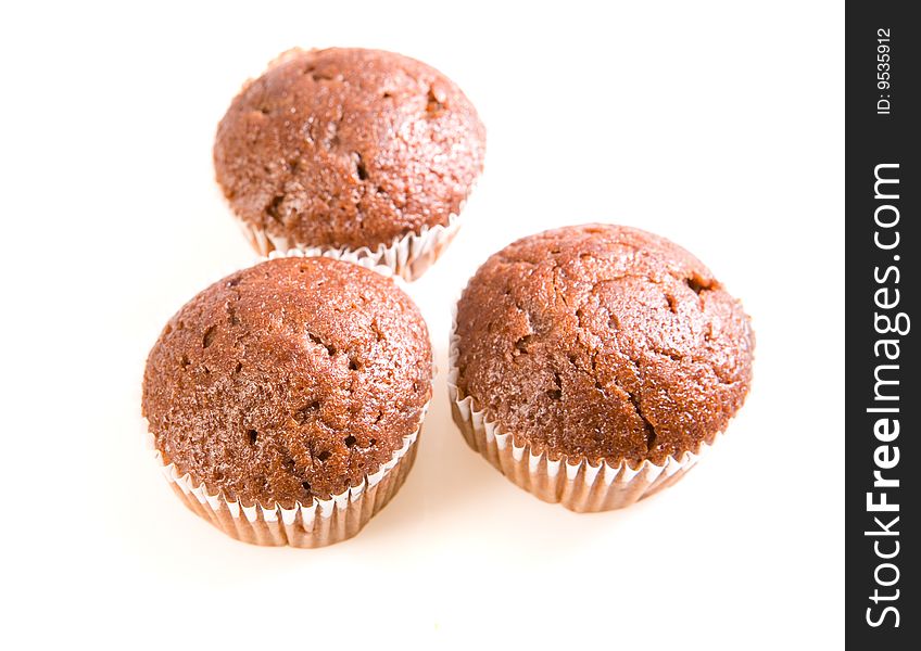 Three chocolate muffins on white ground