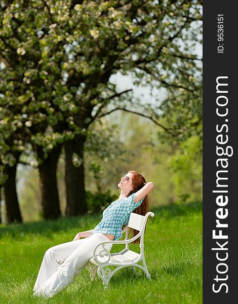 Woman relax under blossom tree in summer