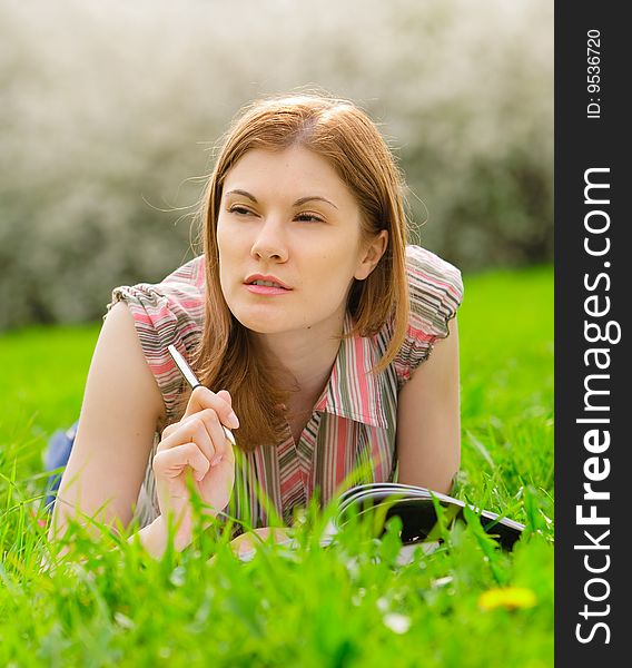 Pretty young woman studying outdoors. Pretty young woman studying outdoors