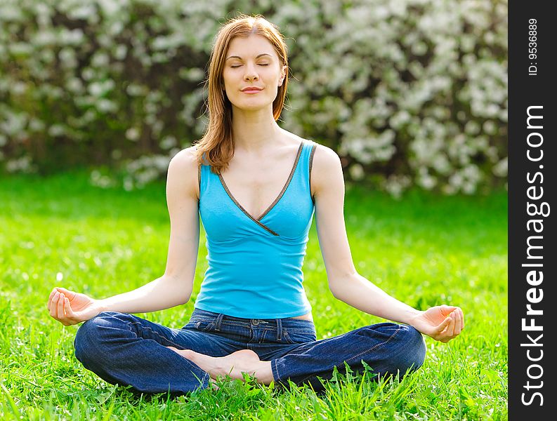 Beautiful woman meditating outdoors