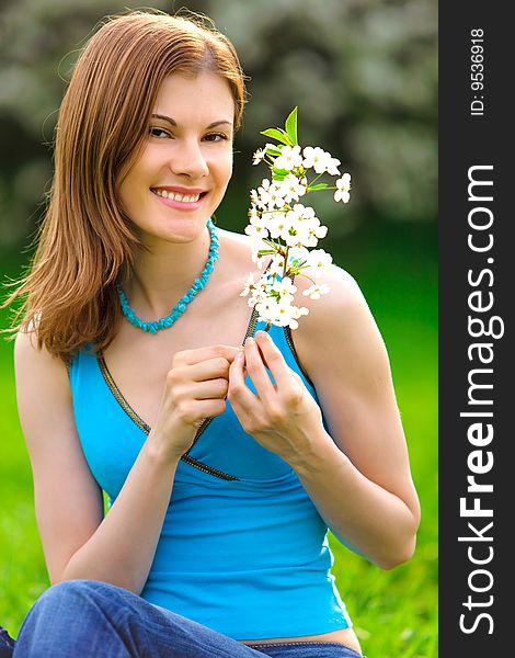 Beautiful young woman with a flower outdoors. Beautiful young woman with a flower outdoors