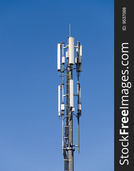 An antenna mast in the blue sky