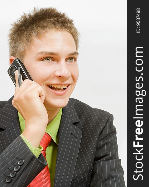 Young happy businessman talking on the cellphone. Young happy businessman talking on the cellphone