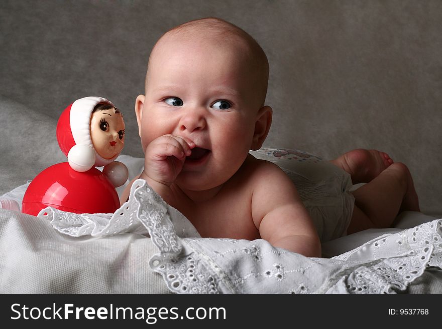 Cheerful 5 months old  baby girl with  toy. Cheerful 5 months old  baby girl with  toy