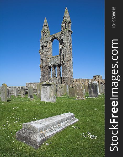 View of St Andrews Cathedral in Scotland with an ancient tombstone in the foreground. Once one of the most important religious centres in Scotland the Abbey declined after the Reformation leaving behind only these still impressive ruins. View of St Andrews Cathedral in Scotland with an ancient tombstone in the foreground. Once one of the most important religious centres in Scotland the Abbey declined after the Reformation leaving behind only these still impressive ruins.