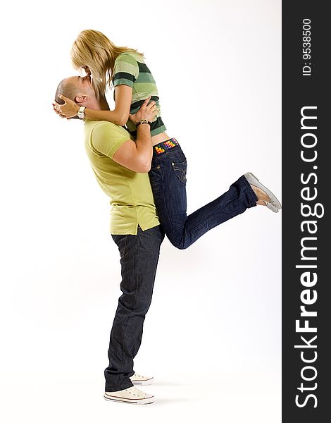 Man holding his girlfriend in the air on white background