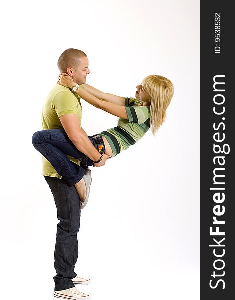 Young man holding his girlfriend in the air