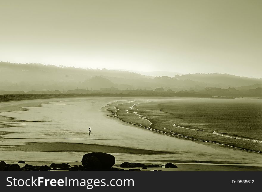 Landscape of the beach with silhouette of person, loneliness concept