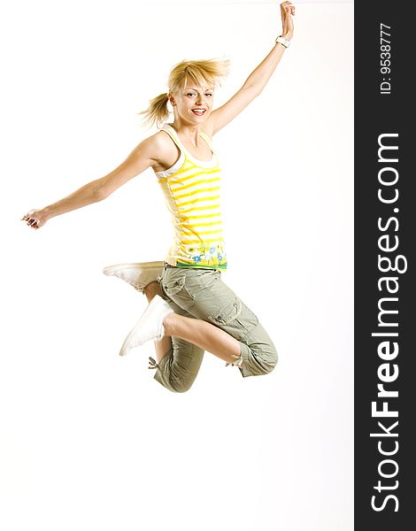 Casual young woman jumps in the air