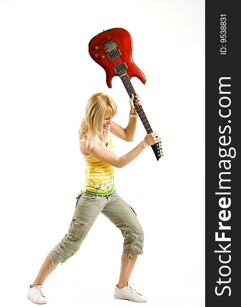 Woman guitarist breaking her guitar on white background