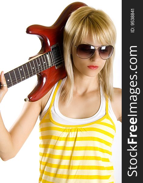 Portrait of an attractive woman guitarist with guitar on her shoulder
