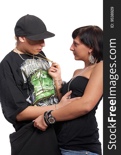 Young couple in love is about to kiss. The woman is pulling the man closer with his necklace. Isolated over white. Young couple in love is about to kiss. The woman is pulling the man closer with his necklace. Isolated over white.