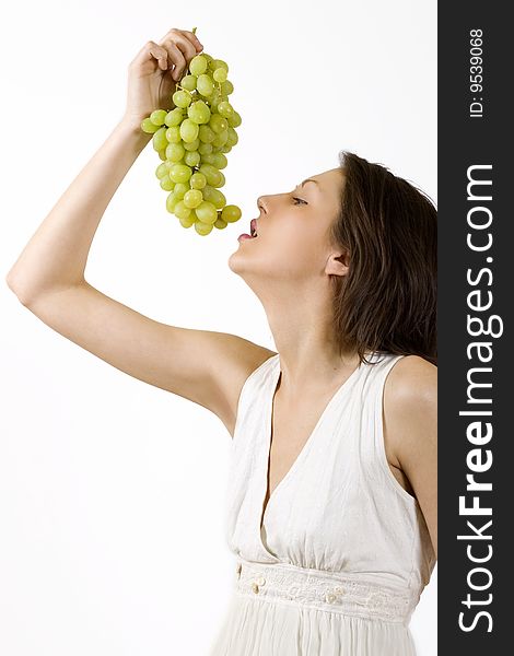 Woman tasting a yellow grape. Woman tasting a yellow grape