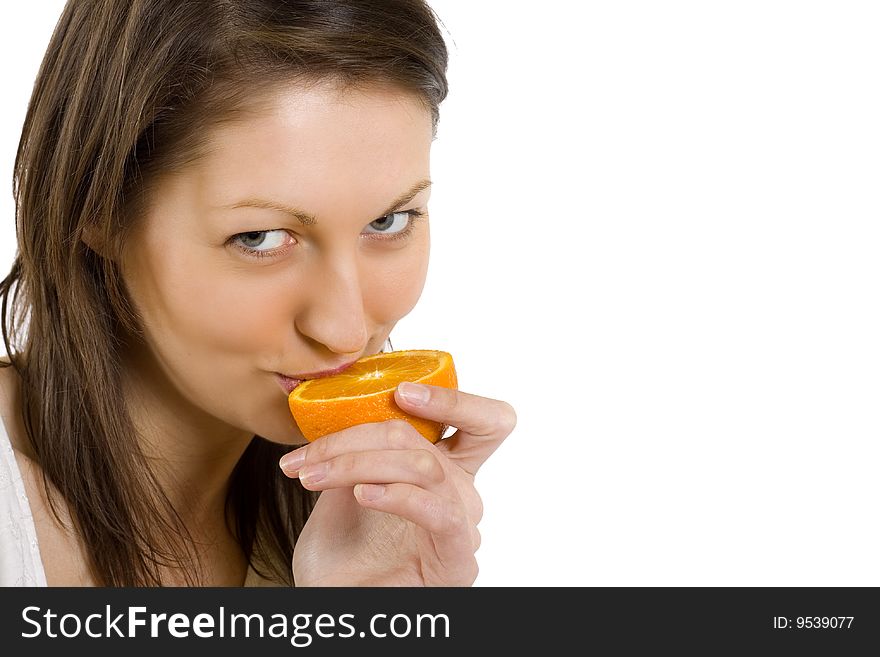 Closeup of a woman tasting an orange