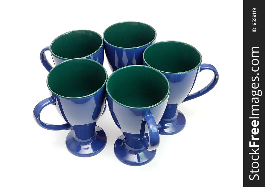 Circle of five blue long-stemmed coffee cups with handles out isolated. Circle of five blue long-stemmed coffee cups with handles out isolated