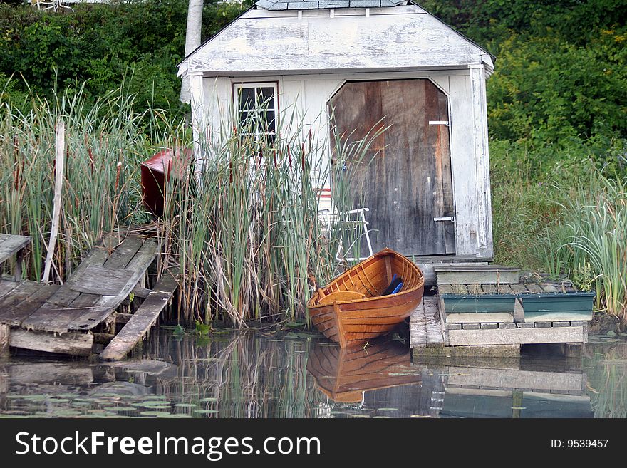 An old shack and a canoe in a peacefulsetting on the Black River Sutton, Ontario