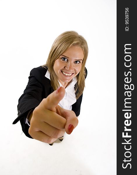 Wide angle picture of an attractive businesswoman pointing at you