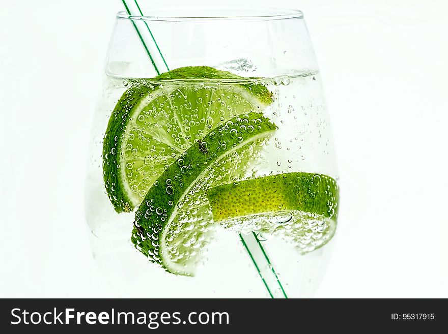 Glass with clear liquid and limes