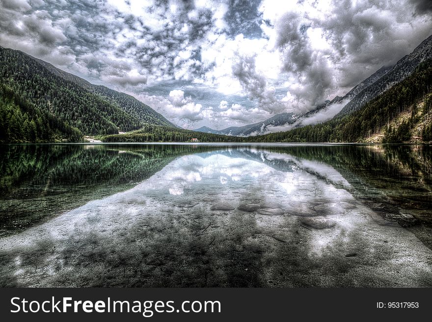 Clouds reflecting on the surface of a mountain lake. Clouds reflecting on the surface of a mountain lake.