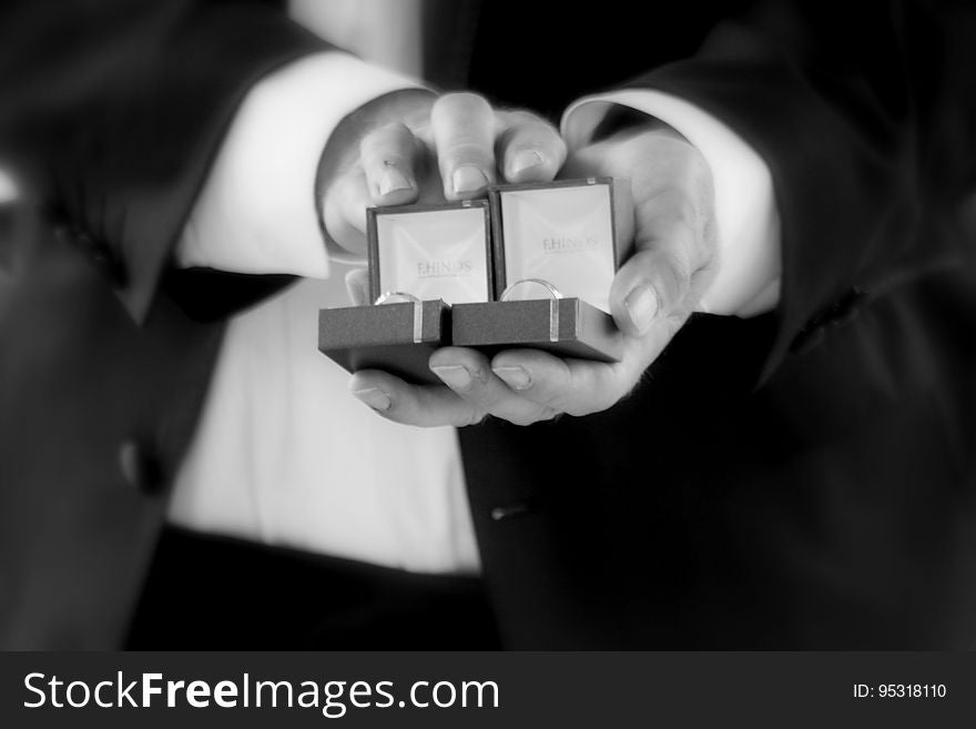 Hands Of Man Holding Open Jewelry Boxes