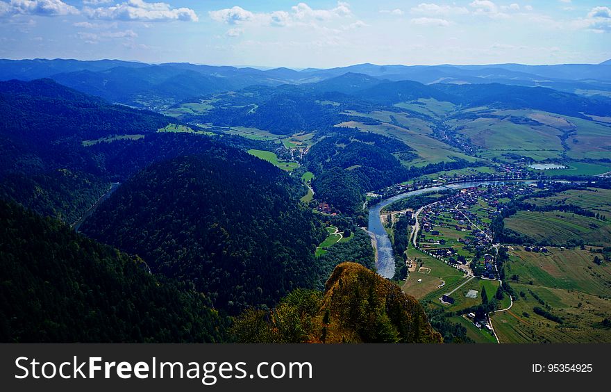 Aerial view of mountains and river curving through countryside. Aerial view of mountains and river curving through countryside.