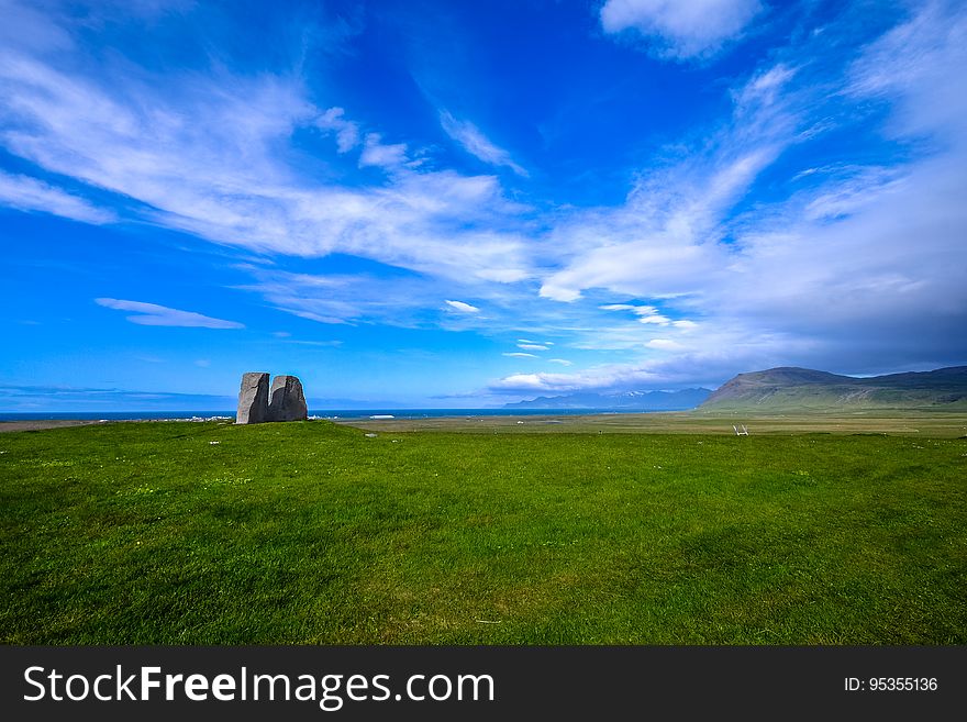 Dramatic blue skies over green fields in countryside on sunny day. Dramatic blue skies over green fields in countryside on sunny day.