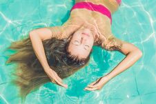 Beautiful Young Woman Floating In Pool Relaxing Top View. Holiday Concept Stock Image