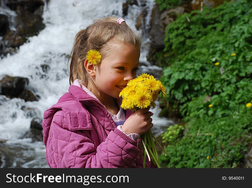 Little girl with yellow flowers.